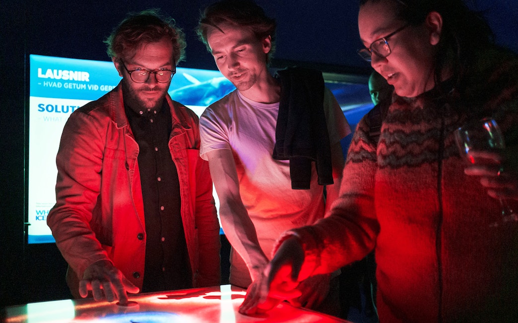 Visitors interacting with an exhibit at Whales of Iceland Museum.