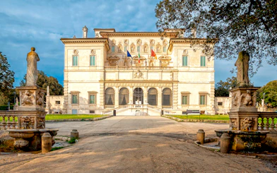 Borghese Gallery facade with statues and garden in Rome, Italy.