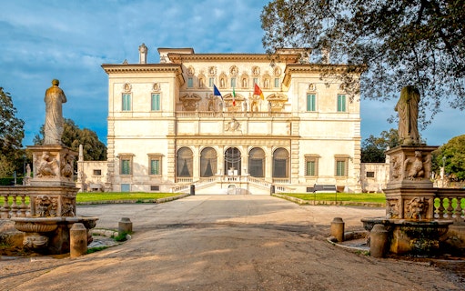 Borghese Gallery facade with statues and garden in Rome, Italy.