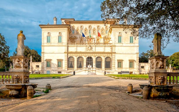 Borghese Gallery facade with statues and garden in Rome, Italy.