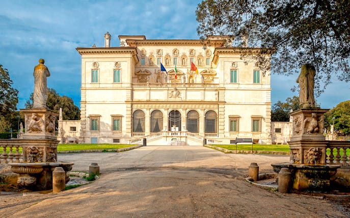 Borghese Gallery facade with statues and garden in Rome, Italy.