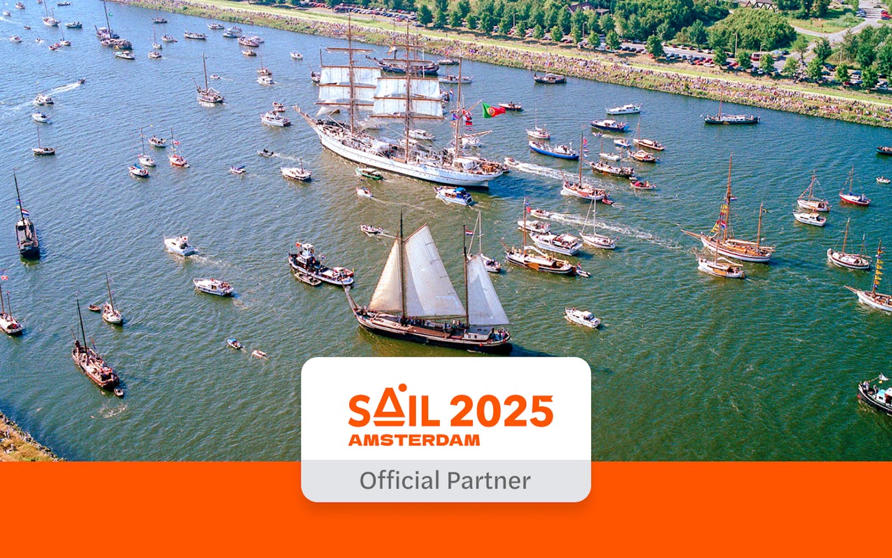 Sail Amsterdam event with numerous ships on the waterway.