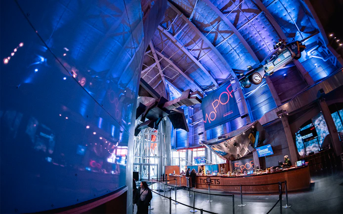 Museum of Pop Culture interior with ticket counter and suspended car, Seattle.