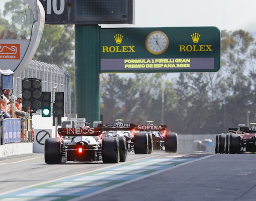F1 cars lined up in the pit lane at Circuit de Barcelona-Catalunya.