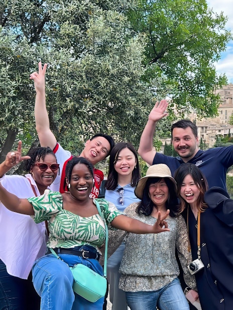 Group enjoying Lavender Full Day Tour with view of Sault village in background.