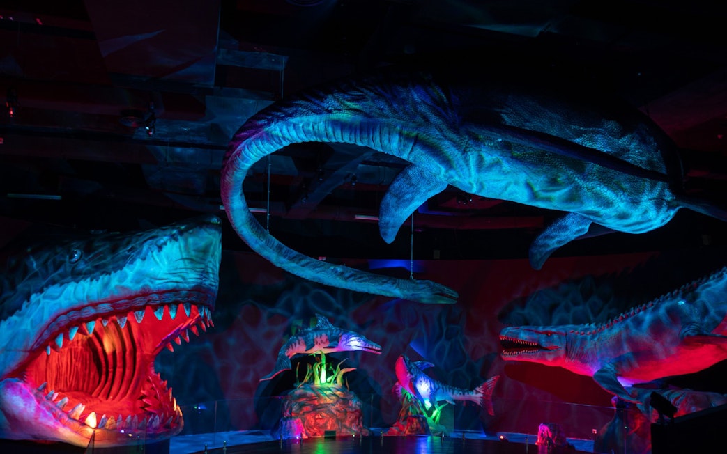 Dinosaurs exhibit at Wetland Studios Putrajaya, Malaysia with vibrant lighting.