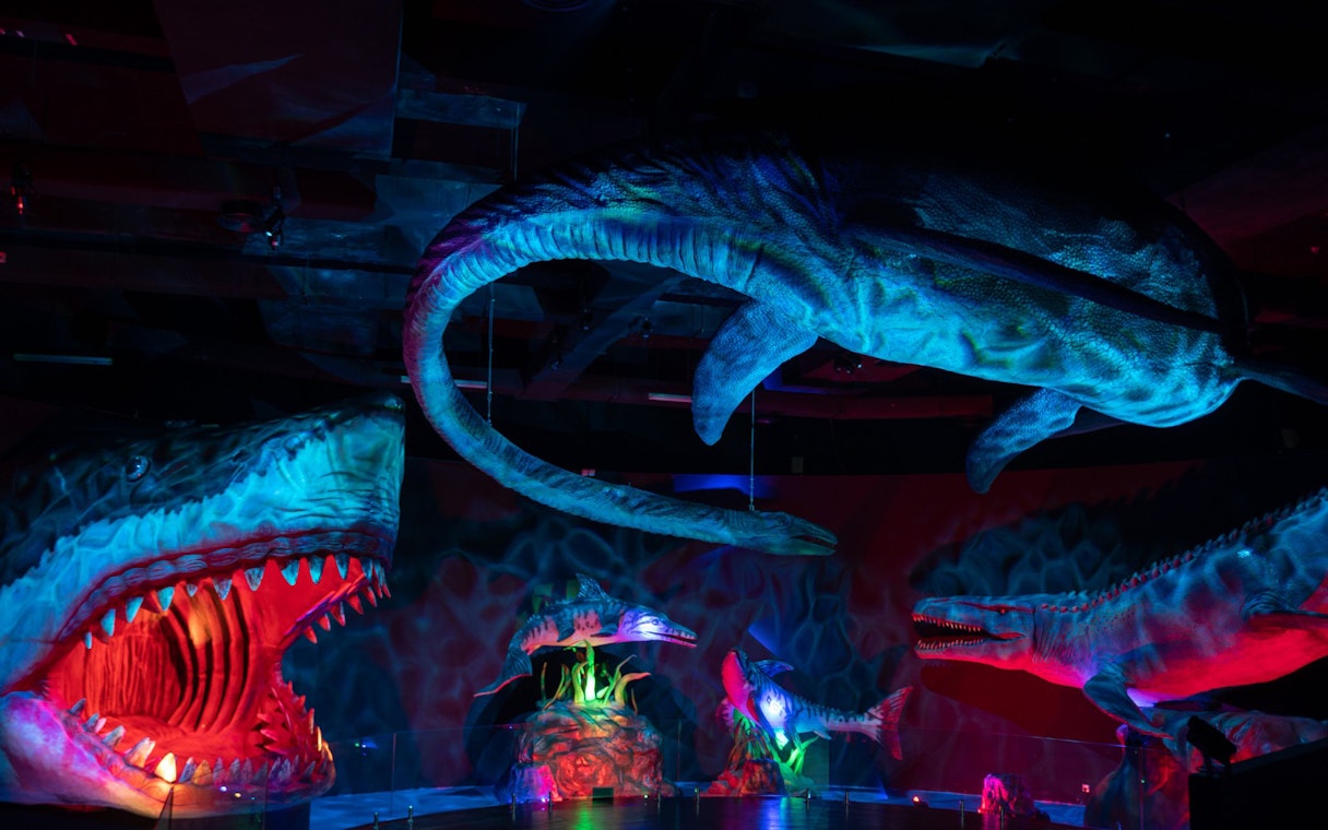 Dinosaurs exhibit at Wetland Studios Putrajaya, Malaysia with vibrant lighting.