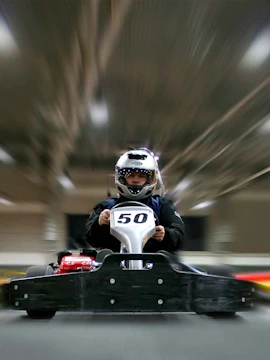 Go-kart racing at Dubai Autodrome indoor track.