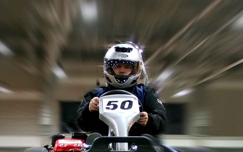 Go-kart racing at Dubai Autodrome indoor track.