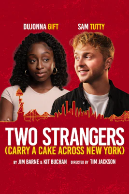 Two people carrying a cake through a bustling street in New York City.
