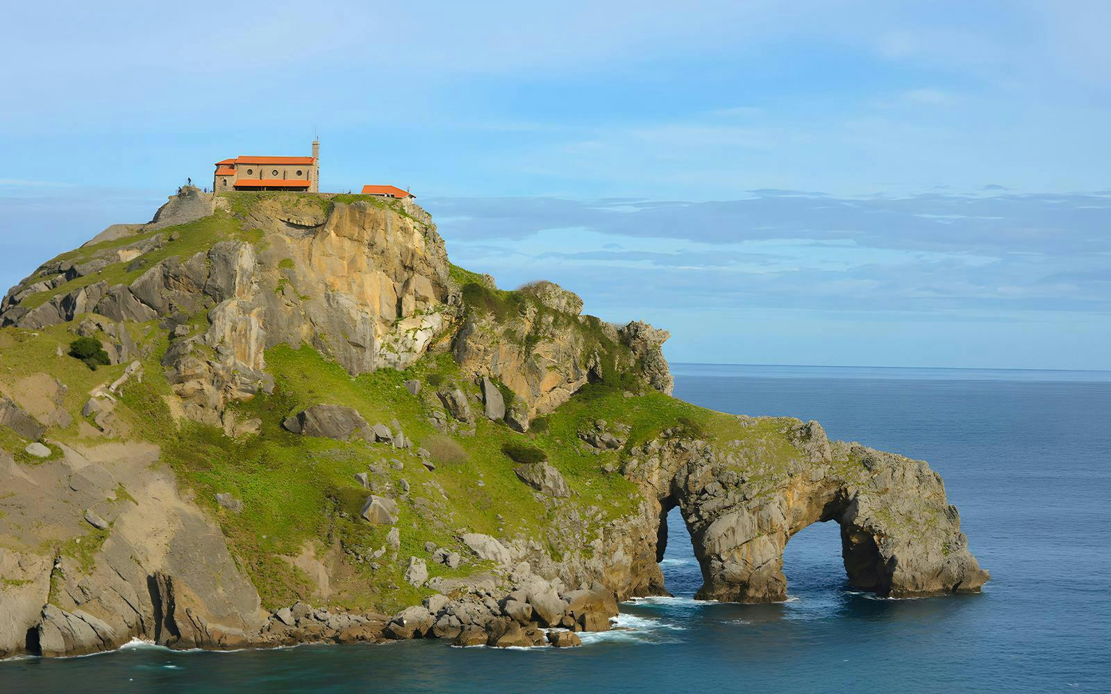 San Juan de Gaztelugatxe islet with church atop rocky cliff by the ocean, Spain.