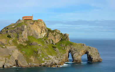 San Juan de Gaztelugatxe islet with church atop rocky cliff by the ocean, Spain.