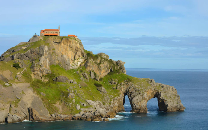 San Juan de Gaztelugatxe islet with church atop rocky cliff by the ocean, Spain.