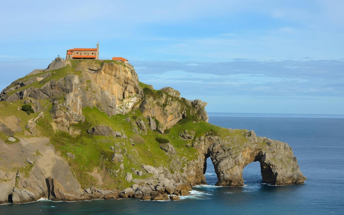 San Juan de Gaztelugatxe islet with church atop rocky cliff by the ocean, Spain.