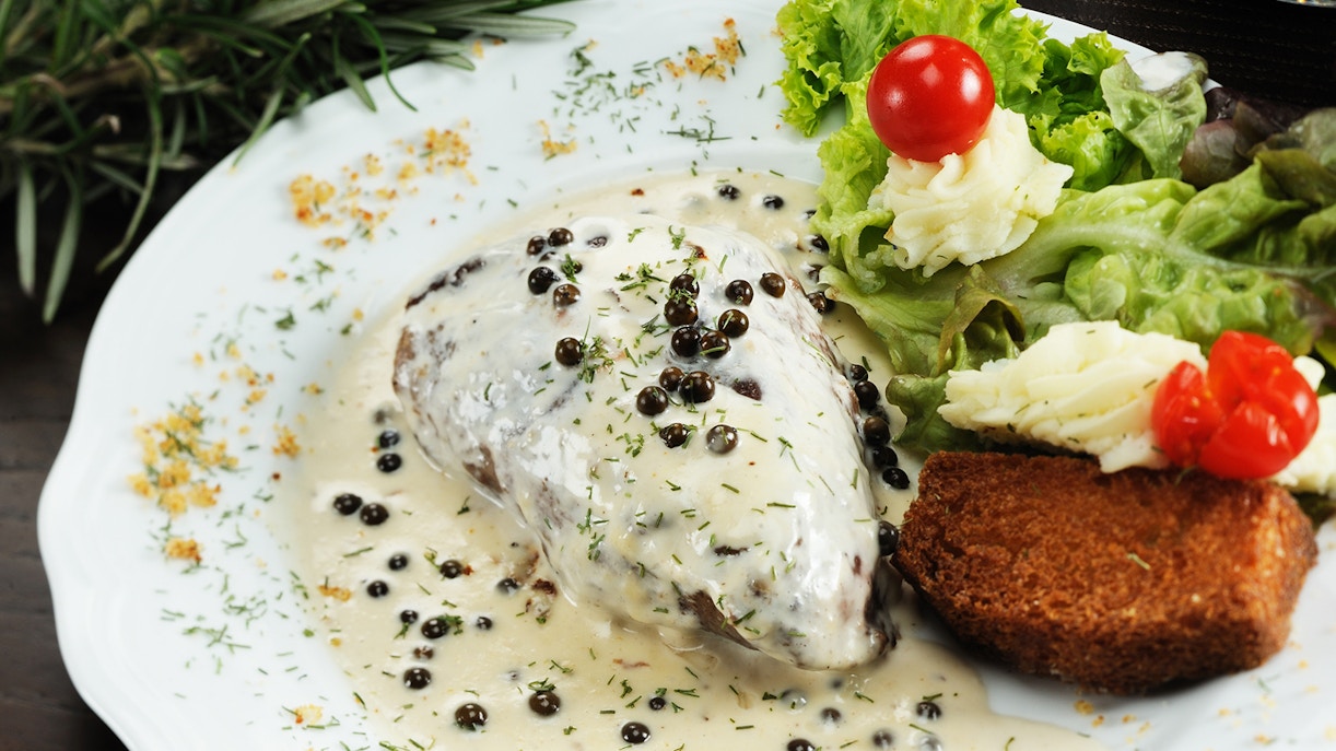 Creamy peppercorn steak with salad and bread at Bardo St James, London.
