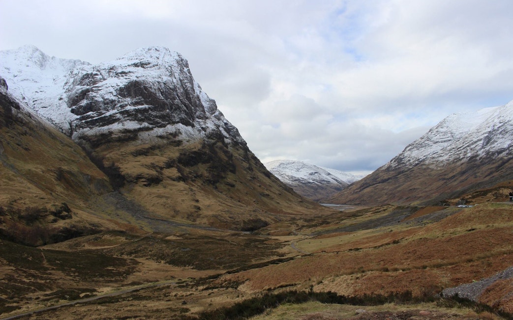 Snow-capped mountains in Glencoe, Scotland, with a valley view.