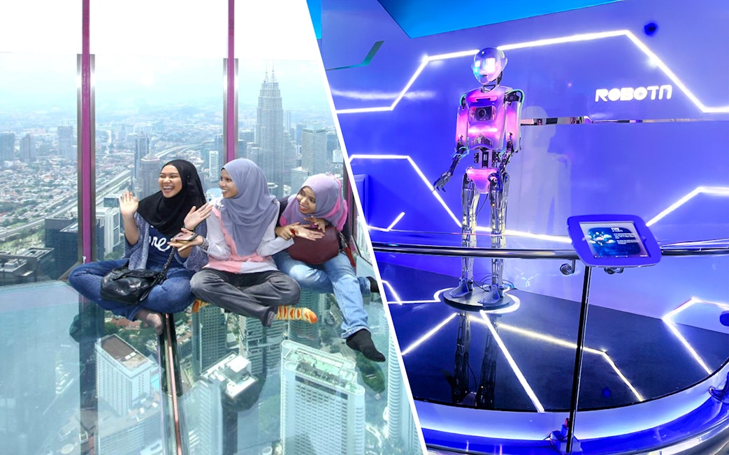 Female tourists sitting on KL Tower observation deck with city view.