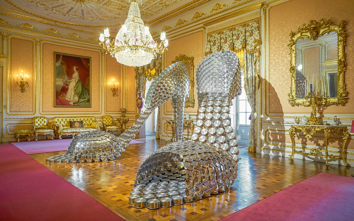 Sculpture of large metallic high heels in ornate room at Liria Palace, Madrid.