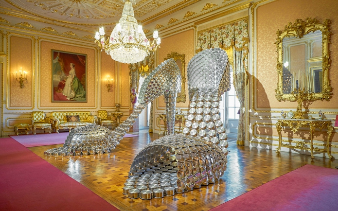 Sculpture of large metallic high heels in ornate room at Liria Palace, Madrid.