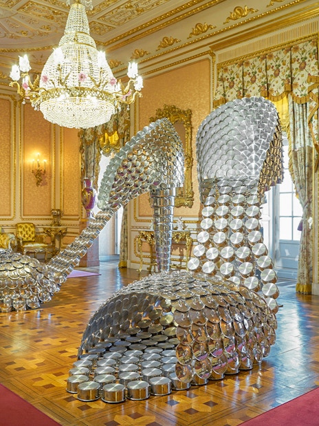 Sculpture of large metallic high heels in ornate room at Liria Palace, Madrid.