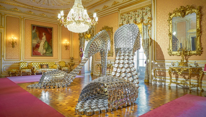 Sculpture of large metallic high heels in ornate room at Liria Palace, Madrid.