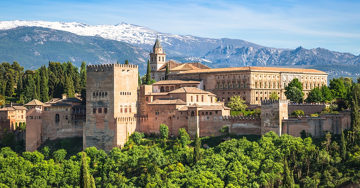 Alhambra palace complex with Sierra Nevada mountains in Granada, Spain.