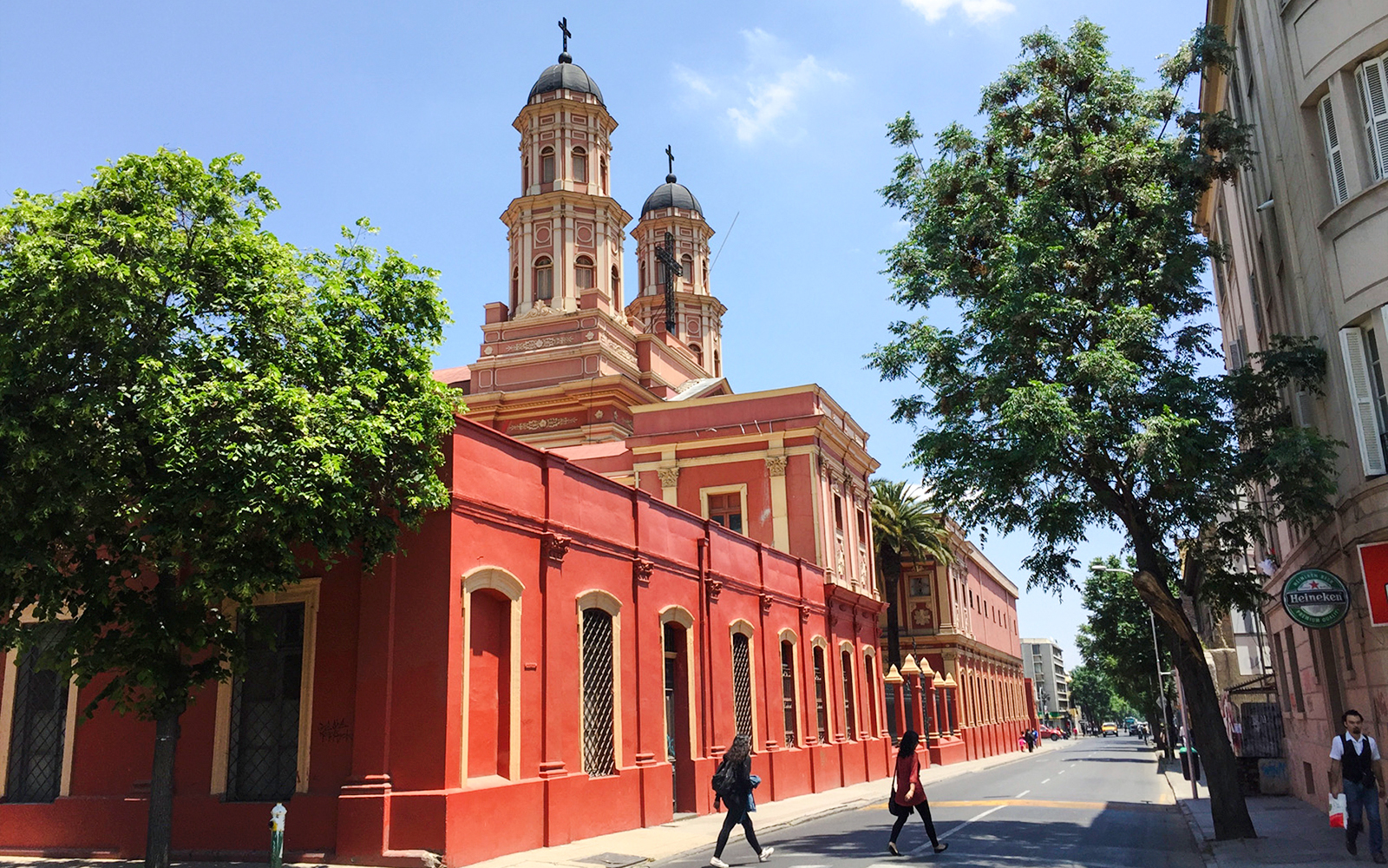 Red church building on a street in Santiago, Chile, part of the Hop-on Hop-off tour.