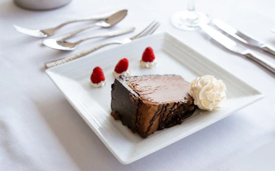Chocolate cake with whipped cream and raspberries on Marina del Rey Premier Dinner Cruise.