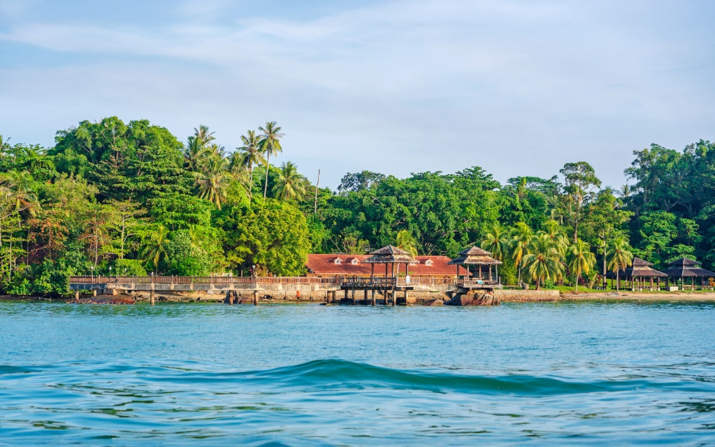 Pavilion and lush greenery on the coast of Pulau Ubin, Singapore.
