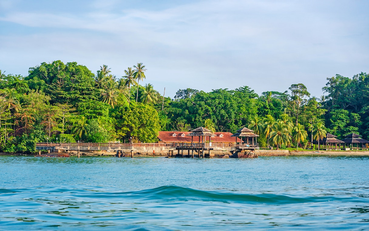 Pavilion and lush greenery on the coast of Pulau Ubin, Singapore.