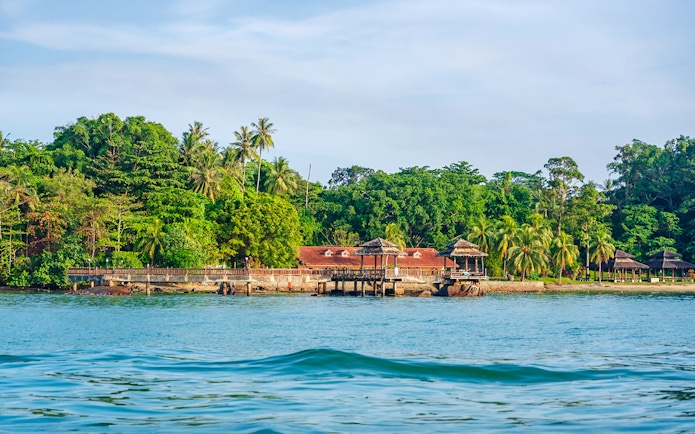 Pavilion and lush greenery on the coast of Pulau Ubin, Singapore.