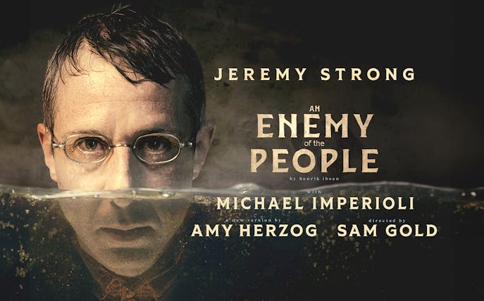 Man with glasses partially submerged in water, text reads "An Enemy of the People" with cast and crew names.