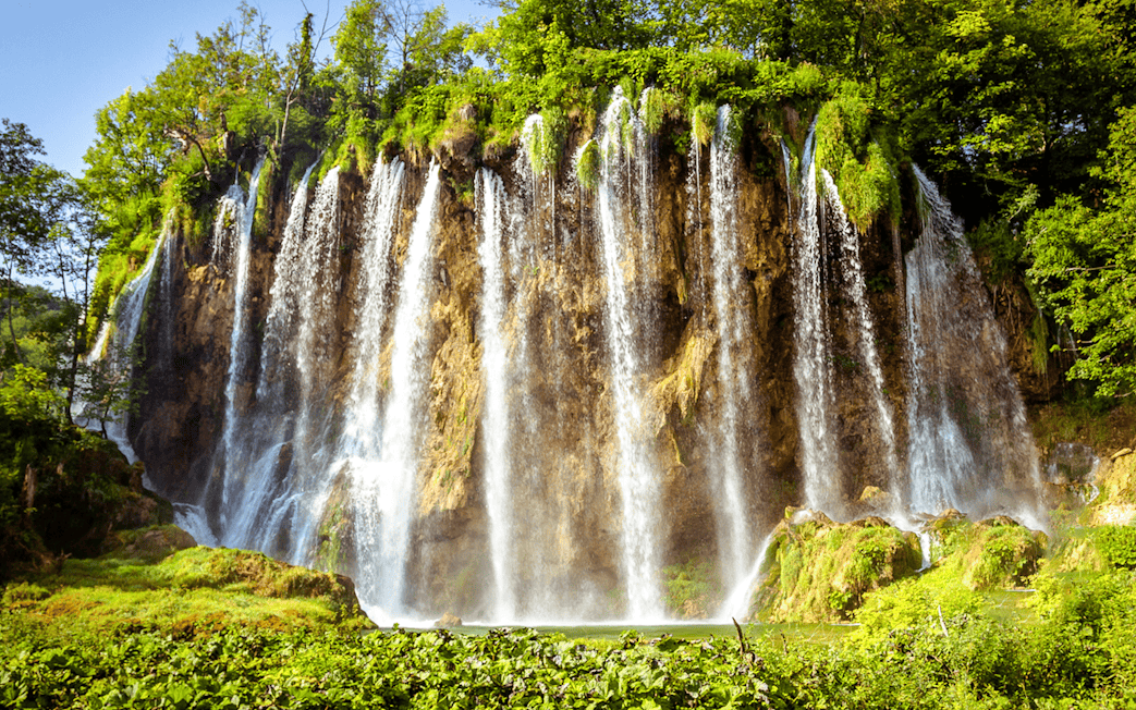 Waterfalls cascading over cliffs at Plitvice Lakes, Croatia.
