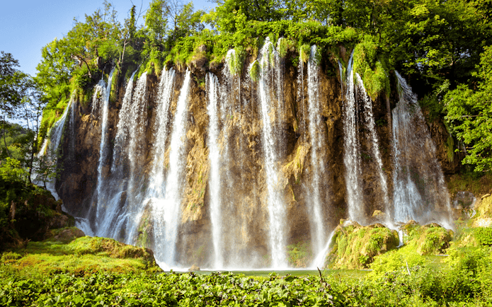 Waterfalls cascading over cliffs at Plitvice Lakes, Croatia.