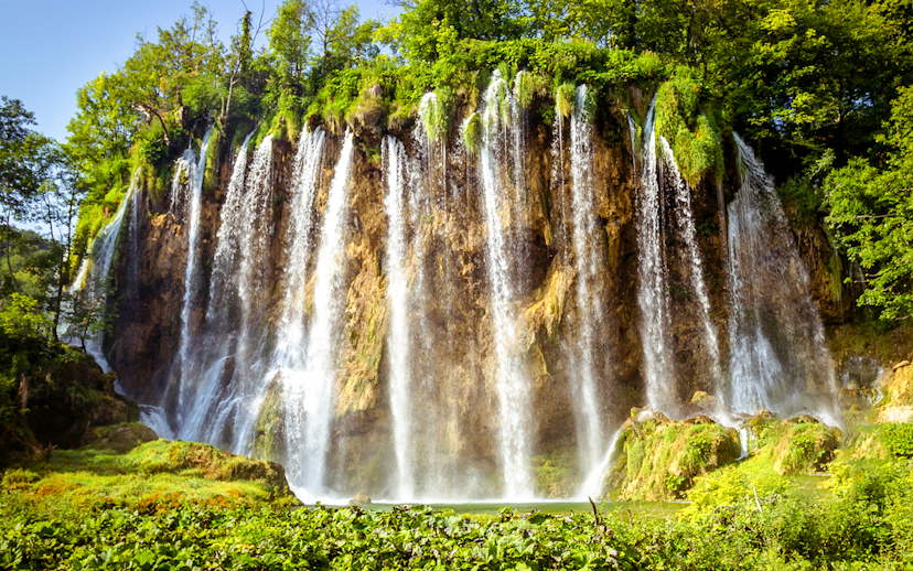 Waterfalls cascading over cliffs at Plitvice Lakes, Croatia.