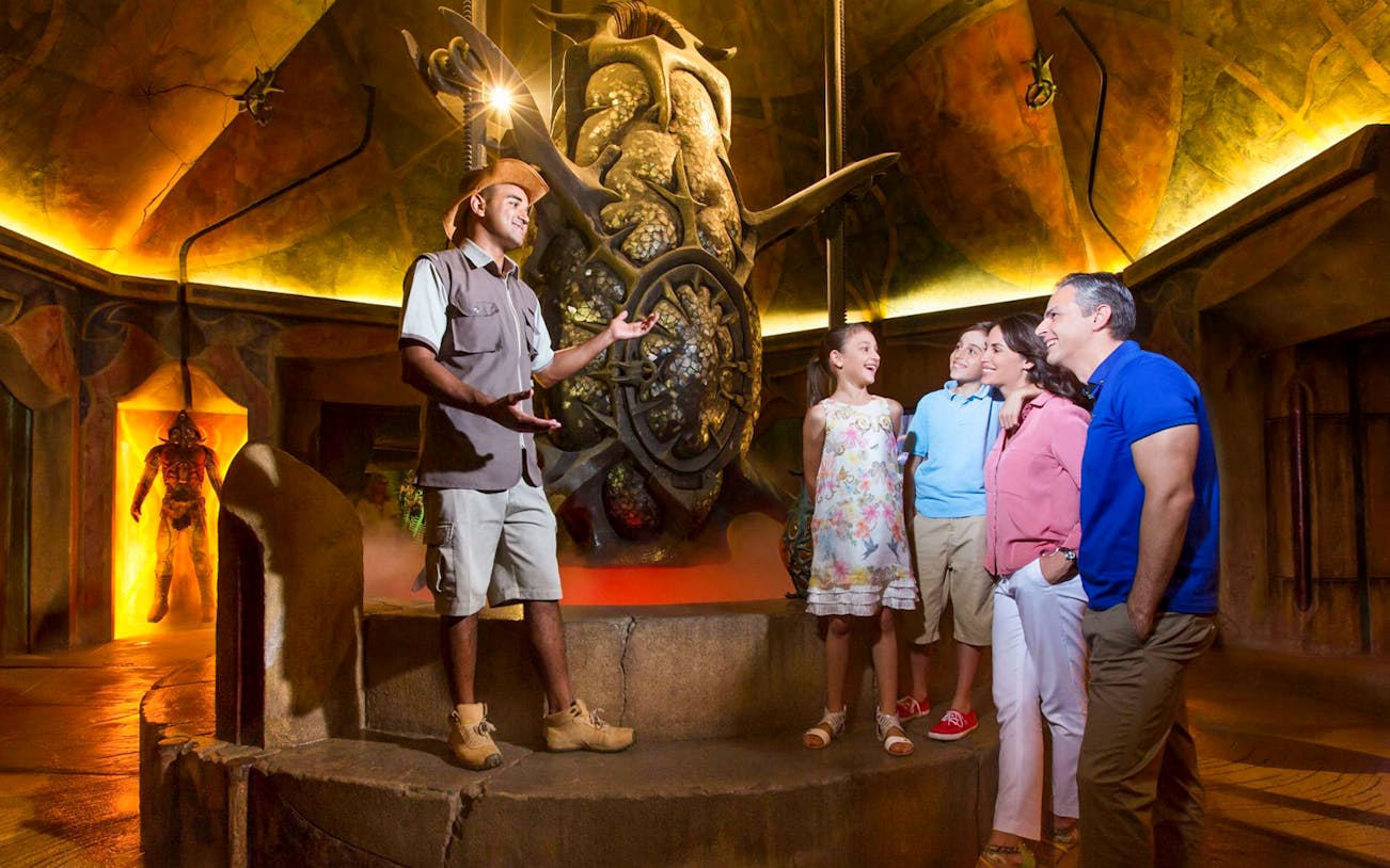 Guide explaining exhibit to family at The Lost Chambers Aquarium.