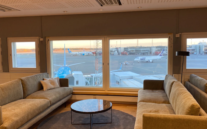 Pearl Lounge seating area with airport runway view at Stockholm Arlanda Terminal 2.