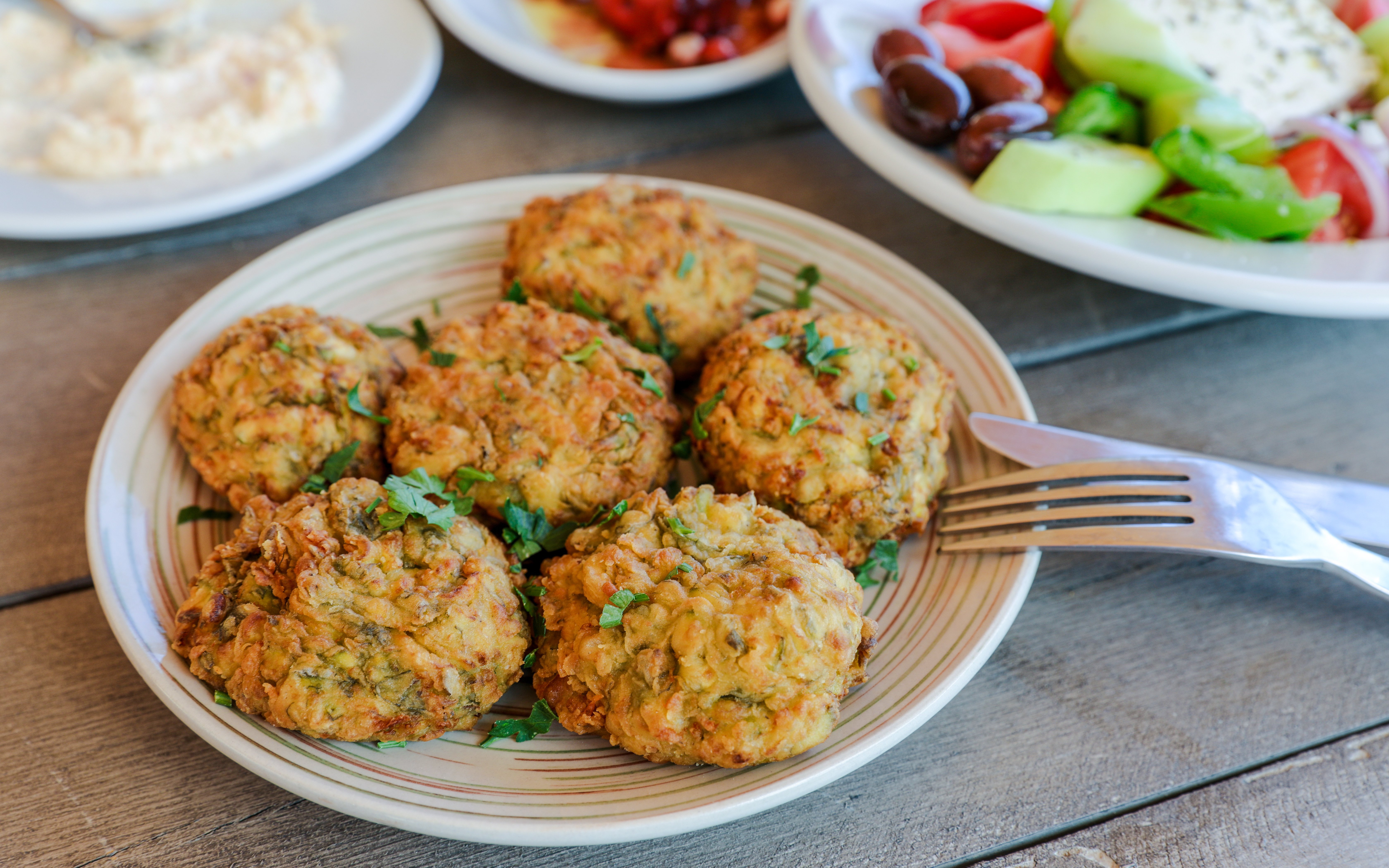 Courgette balls served at Delphi Restaurant with salad and olives.