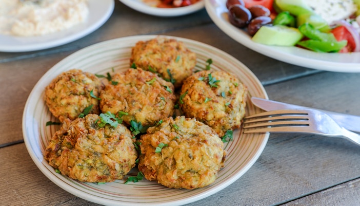 Courgette balls served at Delphi Restaurant with salad and olives.