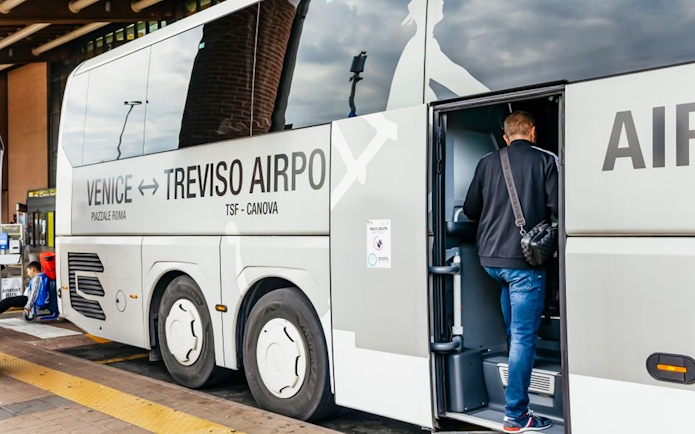 Passenger boarding ATVO airport transfer bus from Venice to Treviso.
