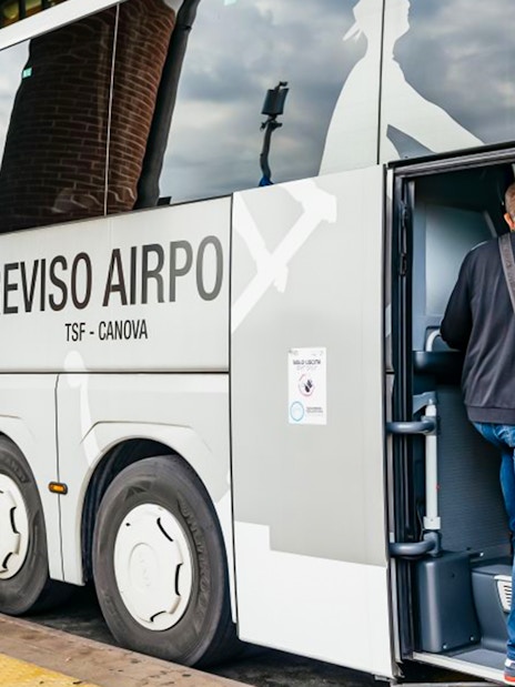 Passenger boarding ATVO airport transfer bus from Venice to Treviso.