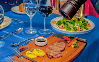Grilled steak and vegetables on a wooden board during Bosphorus dinner cruise, Istanbul.