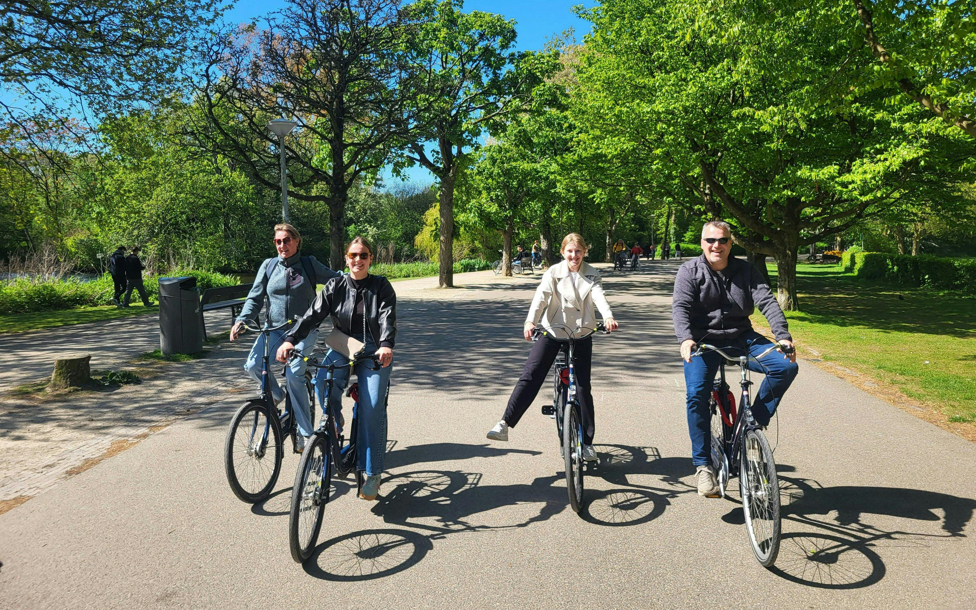 Group biking through a scenic city park on a sunny day.