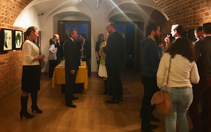 Guests mingling at a Chopin music recital in Old Town, enjoying drinks.