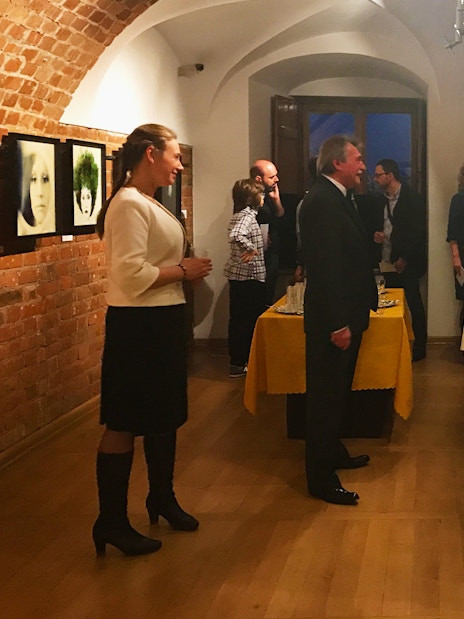 Guests mingling at a Chopin music recital in Old Town, enjoying drinks.