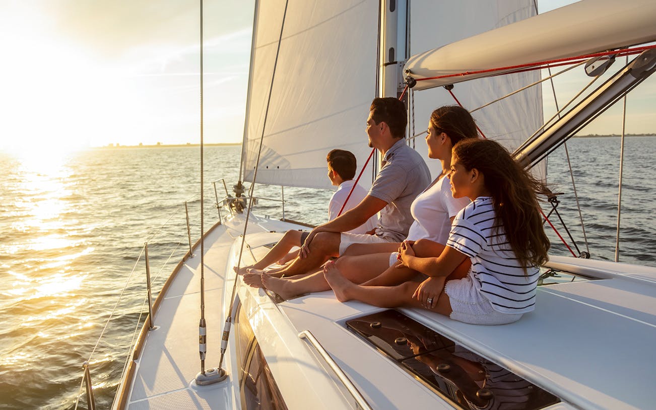 Family enjoying a sunset boat tour near Vulcano Island.