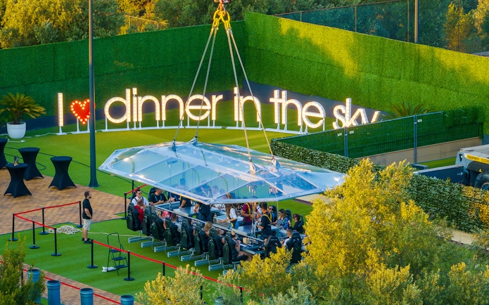 Guests dining at suspended table, Dinner in the Sky, Dubrovnik.