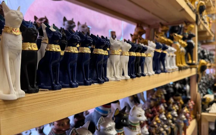 Ancient Egyptian cat statues on display in a Hurghada shop during a private shopping tour.