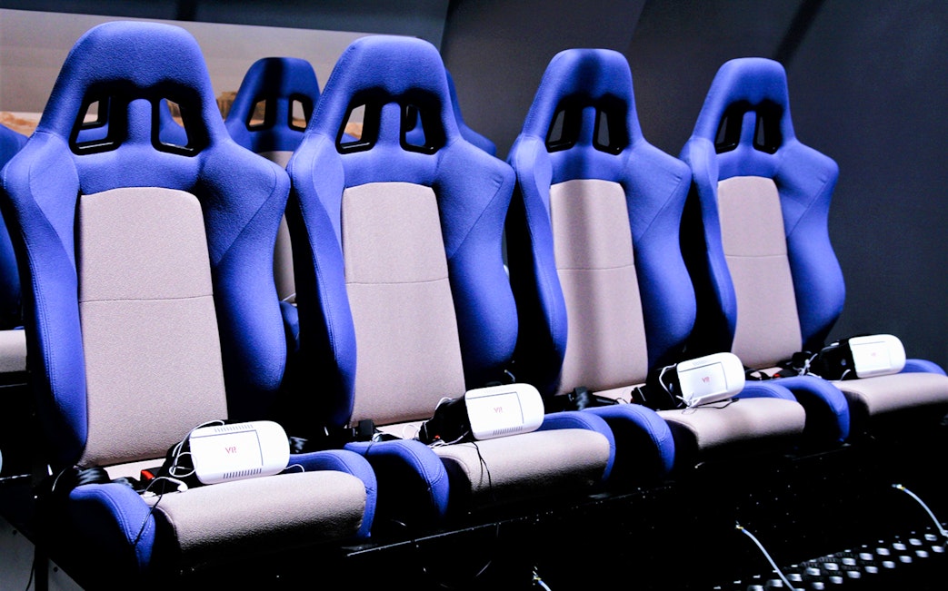 VR seats at DinoVenture attraction with headsets for immersive experience.