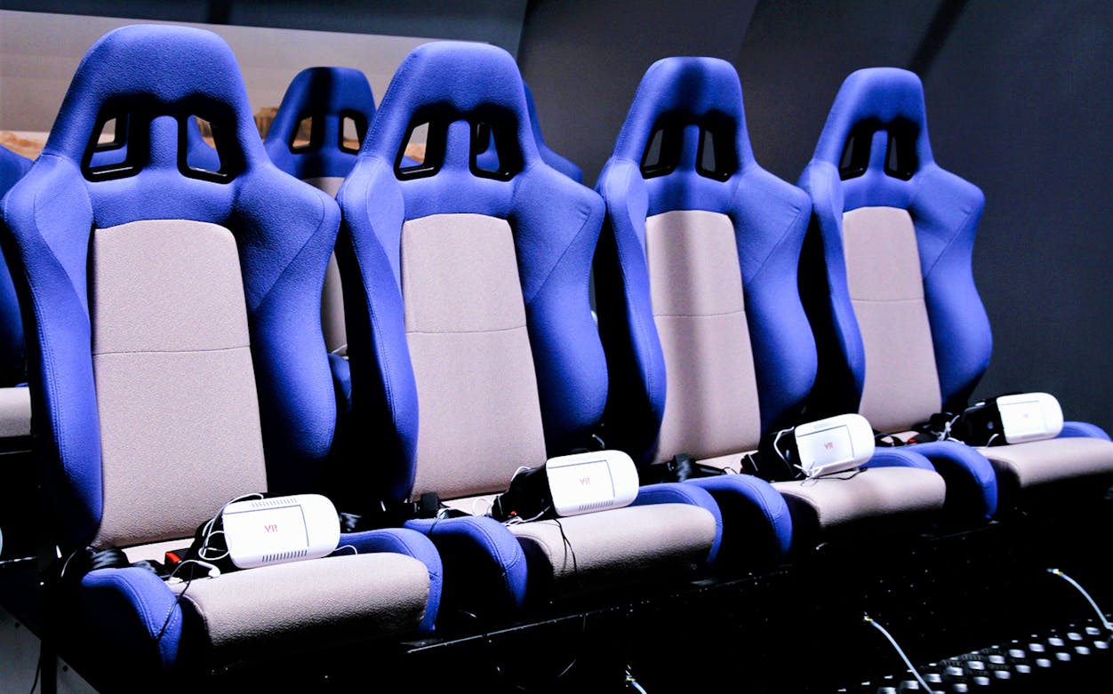 VR seats at DinoVenture attraction with headsets for immersive experience.